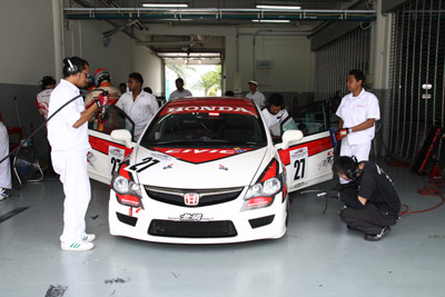 HMRT checking and conducting maintenance on the race car.